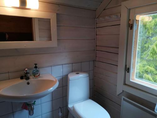 a bathroom with a toilet and a sink at Casa di Sanna in Orimattila
