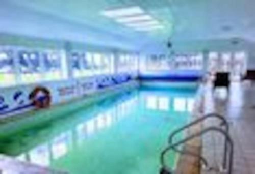 a large swimming pool in a gym with at The Hidden Gem in Galloway Forrest in Balminnoch