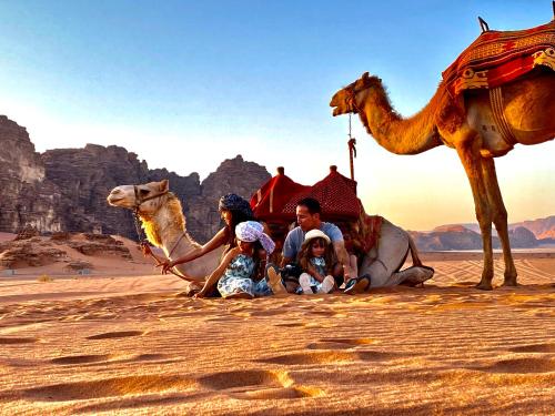 a family and their camel in the desert at Rum Kingdom Camp in Wadi Rum