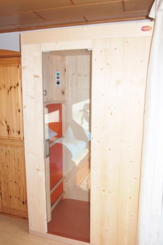 ajar door in a room with wooden walls at Haus Bergwelt in Grän