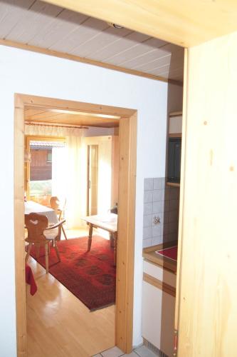 a kitchen with a door open to a living room at Haus Bergwelt in Grän