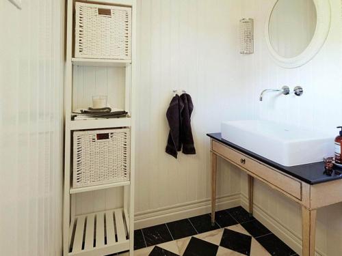 a bathroom with a sink and a mirror at 6 person holiday home in LAHOLM in Laholm