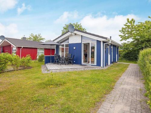 a blue and white house with a patio at 4 person holiday home in GROEMITZ in Grömitz