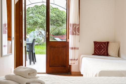 a bedroom with a door leading to a patio at Baja Azzurra in Bari Sardo