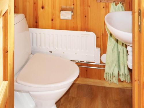 a bathroom with a white toilet and a sink at Holiday home MUNKA-LJUNGBY III in Munka-Ljungby