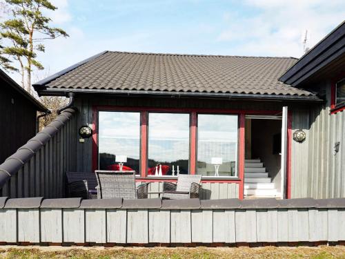 a house with a deck with a table and chairs at 5 person holiday home in str mstad in Strömstad