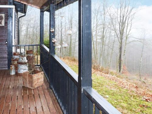 a screened in porch with a view of the woods at 6 person holiday home in KNÄRED in Knäred