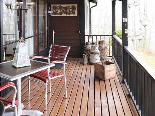 a porch with two chairs and a table on a deck at 6 person holiday home in KNÄRED in Knäred