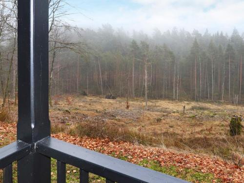 a view of a forest from a porch at 6 person holiday home in KNÄRED in Knäred