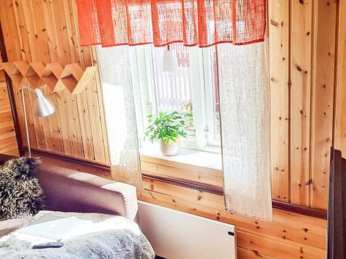 a room with a couch and a window with a plant at Holiday home BORLÄNGE in Borlänge