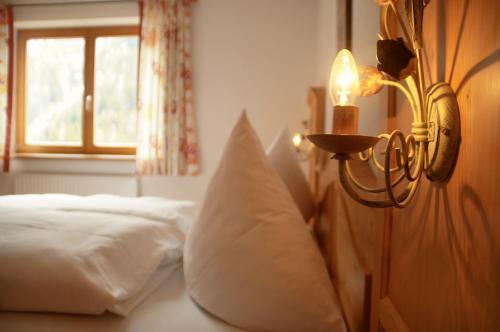 a bedroom with a bed with a light on the wall at Appartement Ilse in Sankt Anton am Arlberg