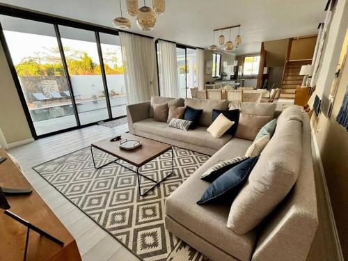 a large living room with a couch and a table at Tush villa is a new, spacious, modern, cheerful in Calodyne