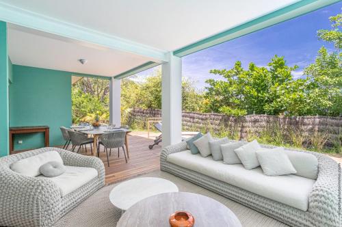 a living room with two couches and a table at Les Villas du Lagon in Le François