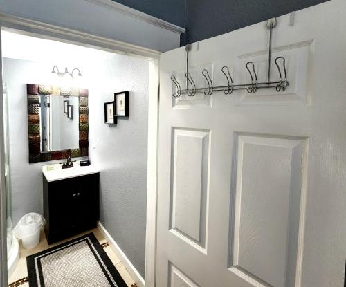 a bathroom with a white door and a sink at Lovely One Bedroom home/ guest house in Lakeland