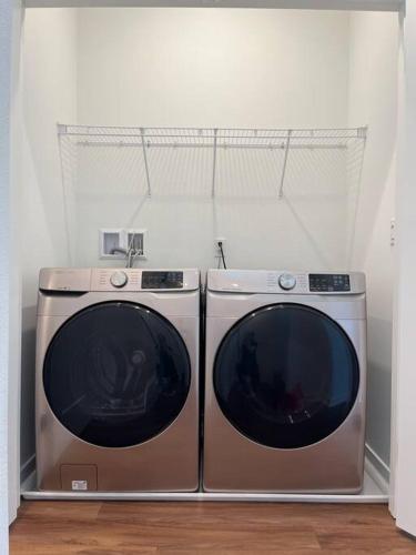 two washing machines are sitting next to each other at Casa Dolce Vita - Luxury Modern Stays - Flexible Monthly Arrangements Available 30-Night Minimum in Irvine