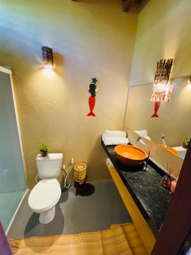 a bathroom with a toilet and a sink at BeachResidence- KiteAliCori , Macapa' in Luis Correia