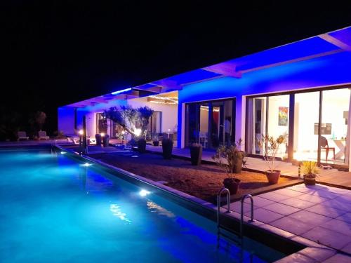 a house with a swimming pool at night at VILLA EDEN in Perchède