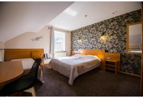Säng eller sängar i ett rum på Hotel L'Escapade