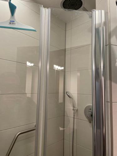 a shower with a glass door in a bathroom at Bernstein in Stuttgart