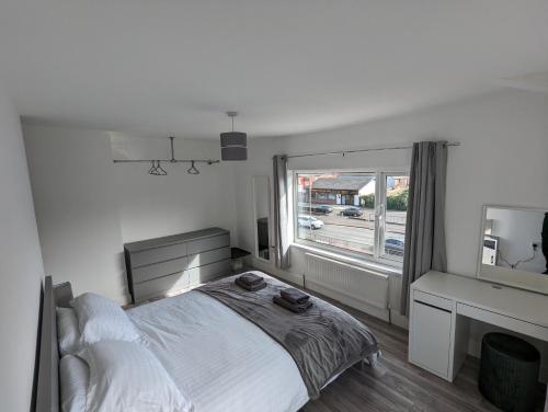 una camera bianca con un letto e una finestra di Windsor Stays 2 a Liverpool