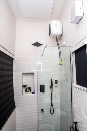 a shower with a glass door in a bathroom at Maple studio+Gym+Snooker board Rhodabode Apt, Nile in Abuja