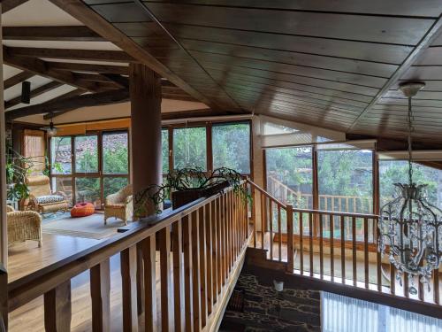 a large room with a wooden ceiling and windows at Casa do Estevo in Francos