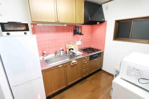 a small kitchen with a sink and a refrigerator at Atorie Bekkan - Vacation STAY 13448 in Shiozawa