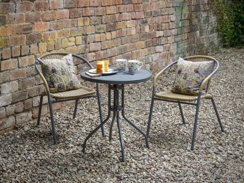 two chairs and a table with two cups on it at Hope Cottage - Uk40055 in Aberfeldy