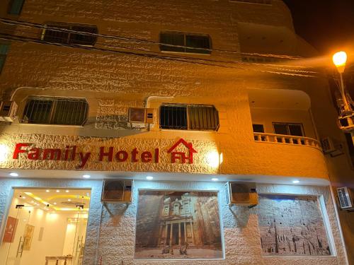 a facade of a family hotel at night at Petra Family Hotel in Wadi Musa