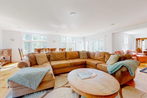 a living room with a brown couch and a table at Sweet Berry Farm in Jamaica