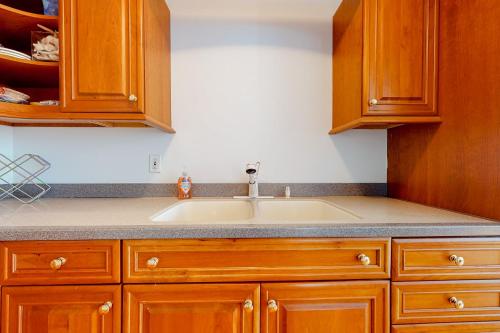 a kitchen with a sink and wooden cabinets at Sweet Berry Farm in Jamaica