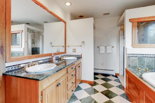 a bathroom with two sinks and a large mirror at Sweet Berry Farm in Jamaica