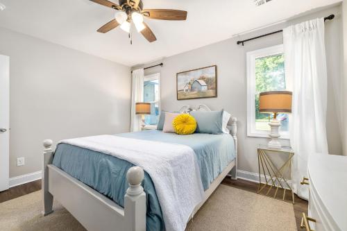 a bedroom with a blue bed with a ceiling fan at Nora Mill in Helen
