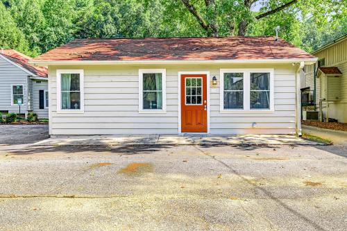 a small white house with a red door at Nora Mill in Helen