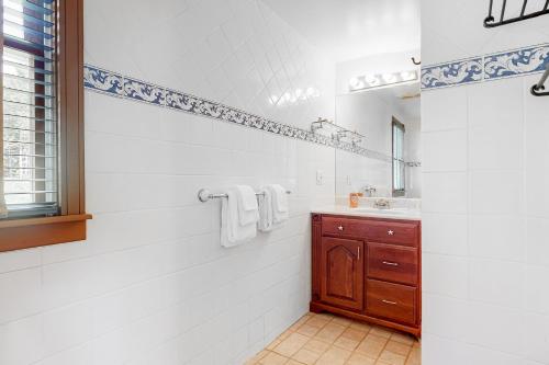 a white bathroom with a sink and a mirror at Sweet Berry Farm in Jamaica