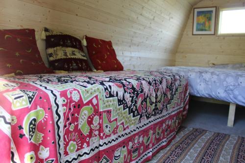 a bed sitting in a room with at Rum Bridge 'Willows' Glamping Pod in Clare