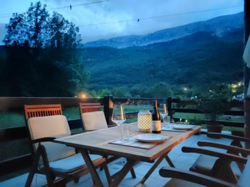 a wooden table with wine glasses on a balcony at L'Artiga in Sesué