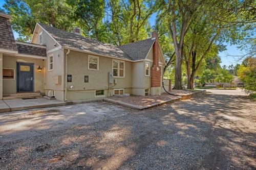 a house with a driveway in front of it at Elegant Old Town Charm - Walk to CSU and Downtown in Fort Collins
