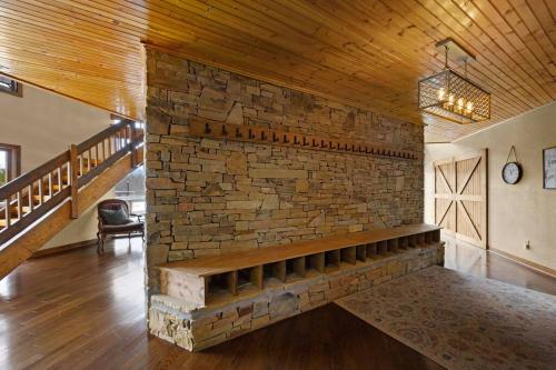 a room with a brick wall with a bench in it at Crestview Estate 5 acres-heated pool-5min to strip in Pigeon Forge