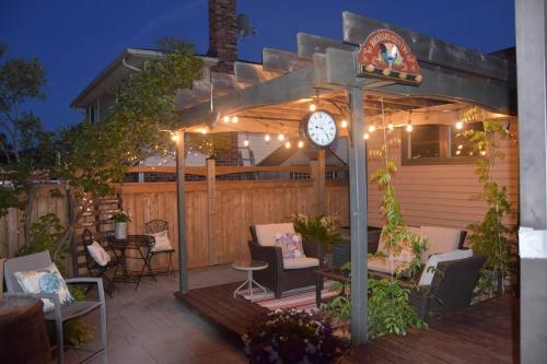 a clock on a pergola on a patio at Cozy Suite with HOT TUB & Highspeed Internet in Grimsby