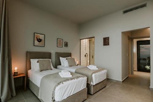 Un dormitorio con dos camas y una ventana. en Saphira Villa, en Katávolos