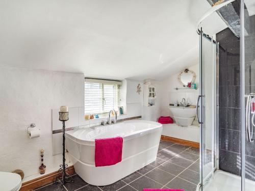 a bathroom with a large tub and a shower at Horseshoes House in Watton