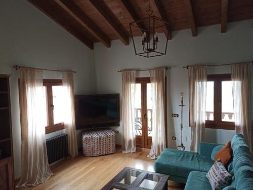 a living room with a blue couch and a tv at Alto el Monte 2 - AR1414 in Bocines