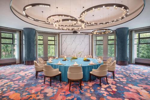 a conference room with a blue table and chairs at Radisson Collection Hotel, Xing Guo Shanghai in Shanghai