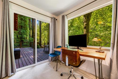 a home office with a desk and a large window at Caz Cabin 6 in Cazadero
