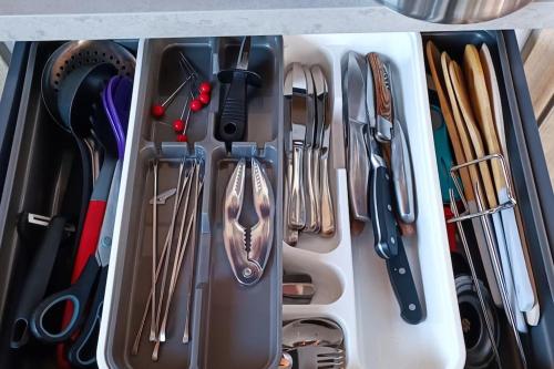 a white drawer filled with utensils at Dormir à l'usine Loft industriel Atypique in Saint-Quentin-Lamotte-Croix-au-Bailly