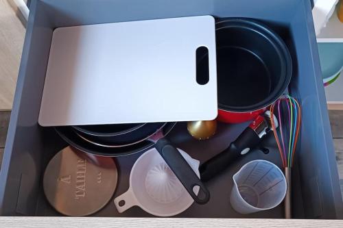 a drawer filled with cooking utensils and a pot at Dormir à l'usine Loft industriel Atypique in Saint-Quentin-Lamotte-Croix-au-Bailly
