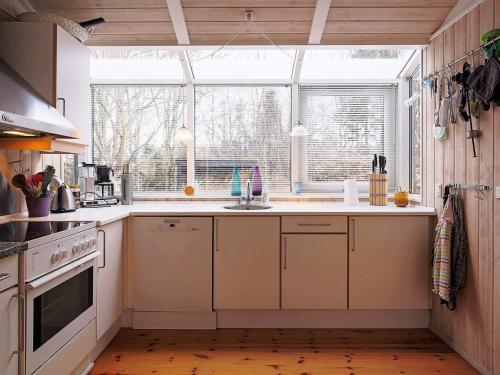 a kitchen with a sink and a window at 8 person holiday home in Tisvildeleje in Tisvildeleje