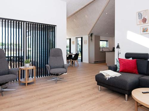 a living room with a couch and chairs and a table at 12 person holiday home in Ansager-By Traum in Ansager