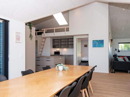 a dining room and kitchen with a large wooden table at 12 person holiday home in Ansager-By Traum in Ansager